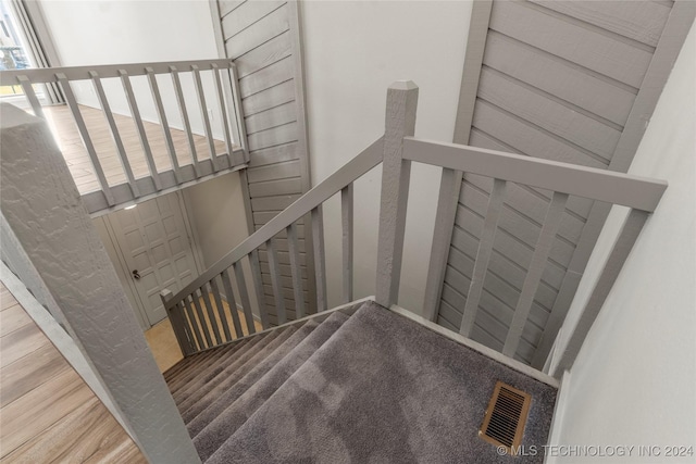 staircase featuring hardwood / wood-style floors