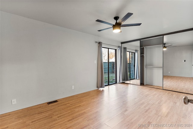 spare room featuring ceiling fan and light hardwood / wood-style flooring