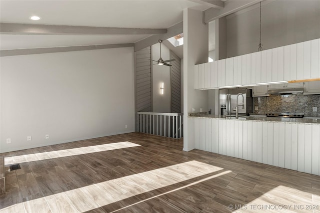 kitchen featuring hardwood / wood-style floors, high vaulted ceiling, ceiling fan, beamed ceiling, and light stone counters