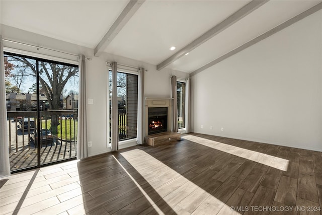 unfurnished living room with lofted ceiling with beams and wood-type flooring