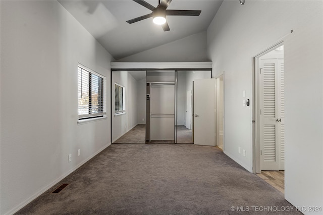 unfurnished bedroom featuring light carpet, high vaulted ceiling, and ceiling fan