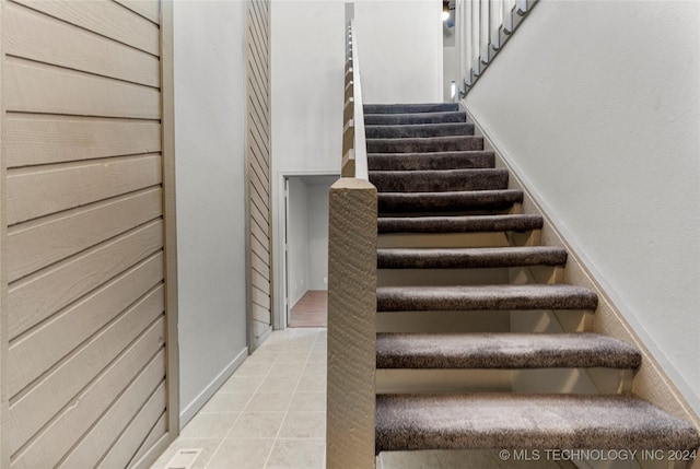 stairway featuring tile patterned floors