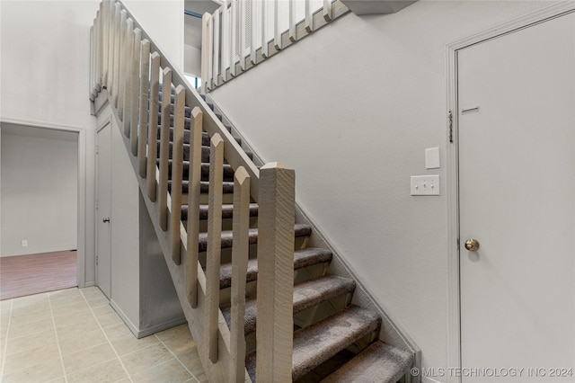 stairs featuring tile patterned flooring