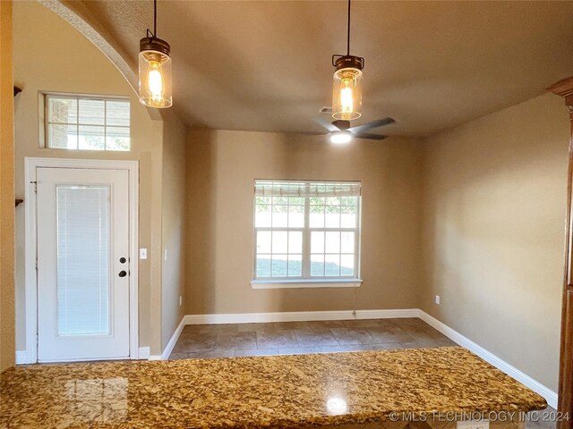 tiled entrance foyer featuring ceiling fan