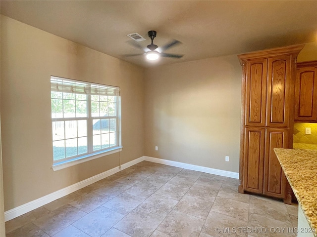 unfurnished dining area featuring ceiling fan