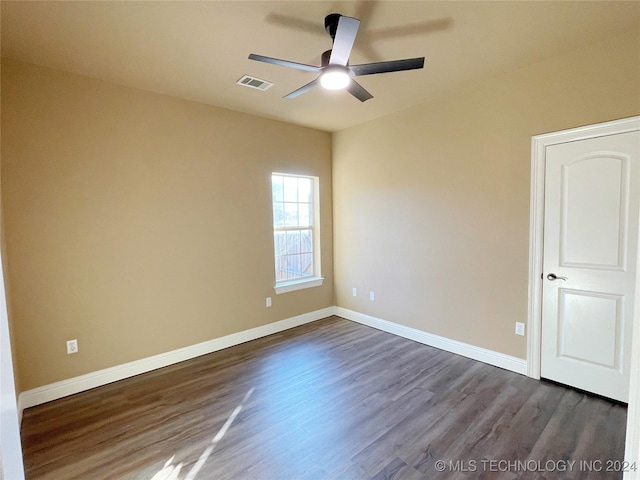 unfurnished room featuring dark hardwood / wood-style floors and ceiling fan