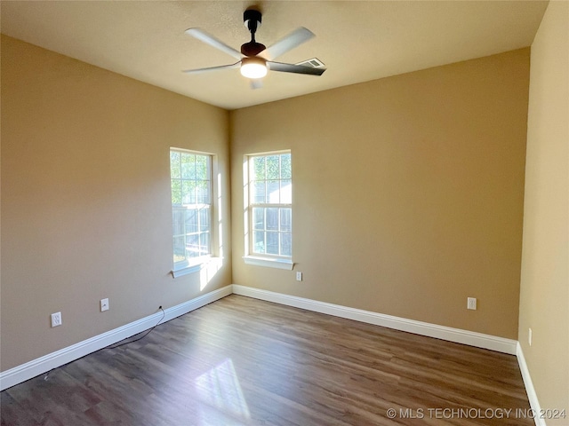 spare room with hardwood / wood-style floors and ceiling fan