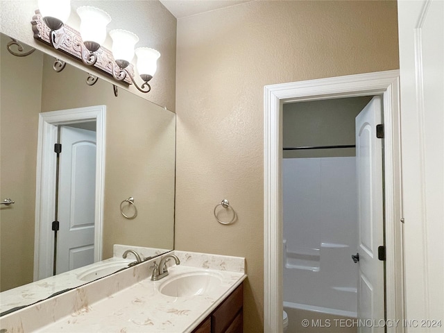 full bathroom featuring vanity,  shower combination, and toilet