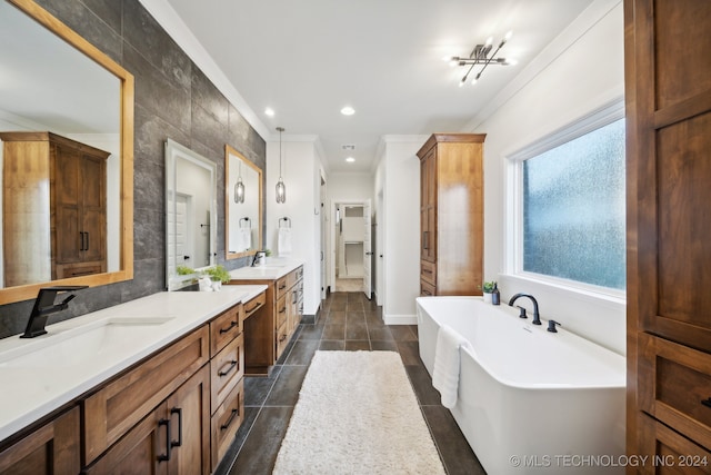 bathroom featuring a washtub, tile patterned floors, vanity, tile walls, and ornamental molding