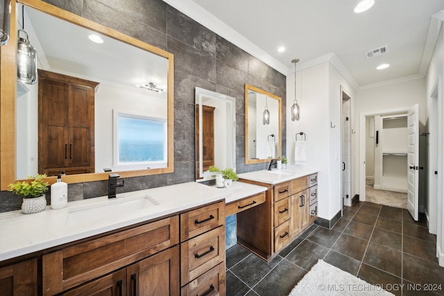 bathroom featuring tile patterned flooring, vanity, tile walls, and crown molding