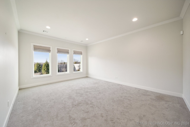 carpeted empty room featuring crown molding