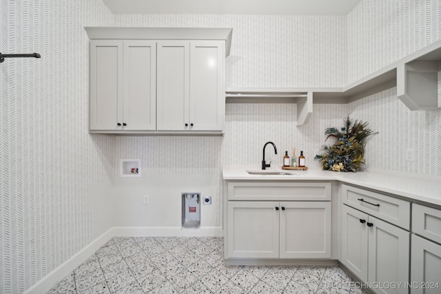 laundry room with hookup for an electric dryer, cabinets, sink, and washer hookup