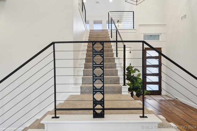 stairway with hardwood / wood-style flooring