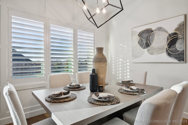 dining room featuring wood-type flooring and a notable chandelier