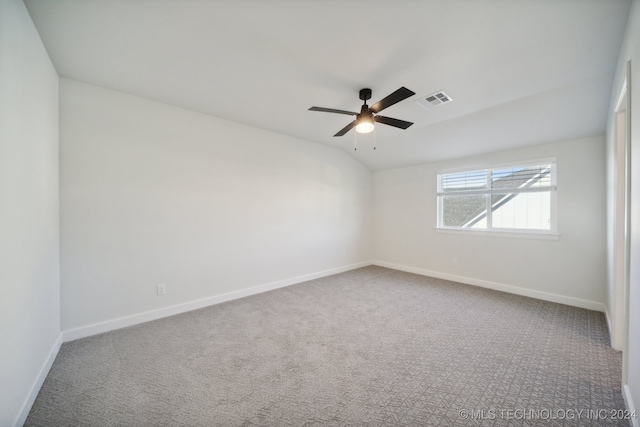 empty room with ceiling fan, carpet, and lofted ceiling