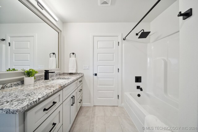 bathroom with tile patterned flooring, vanity, and shower / tub combination