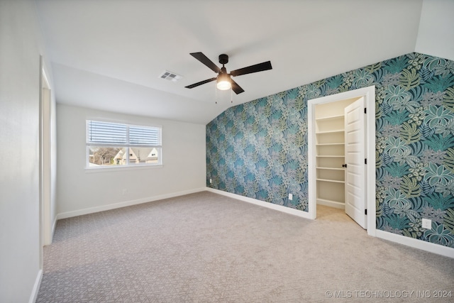 interior space with ceiling fan and lofted ceiling