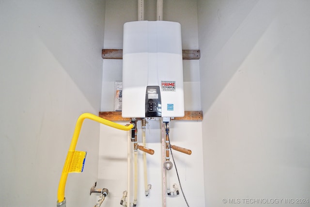 utility room featuring tankless water heater