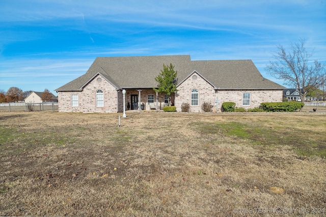 french country inspired facade featuring a front yard