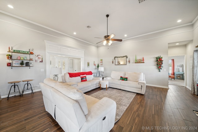 living room featuring dark hardwood / wood-style flooring, ceiling fan, and ornamental molding