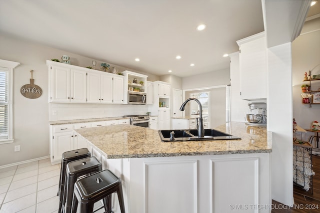 kitchen with plenty of natural light, sink, kitchen peninsula, and stainless steel appliances