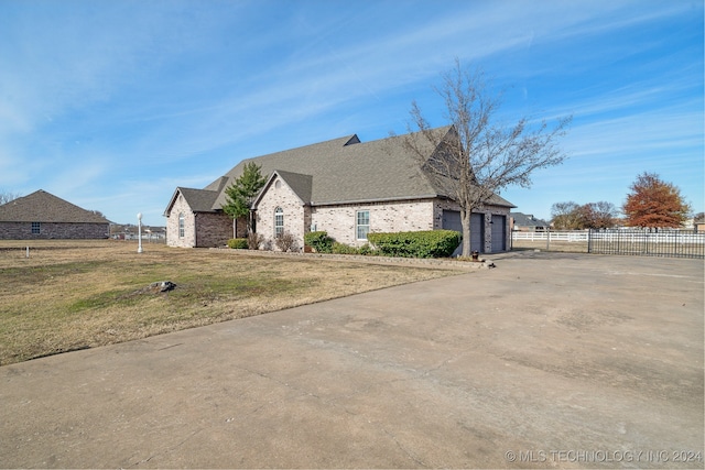 view of front of house featuring a garage and a front lawn