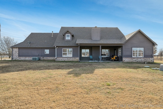 rear view of house featuring a yard and cooling unit