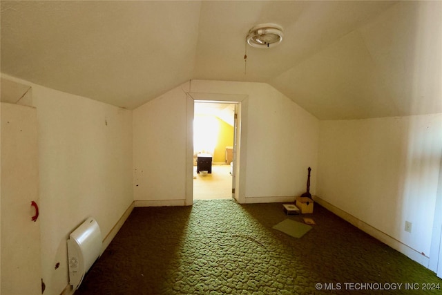 bonus room featuring dark carpet and lofted ceiling