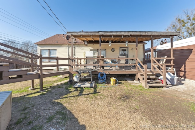 back of property featuring a wooden deck