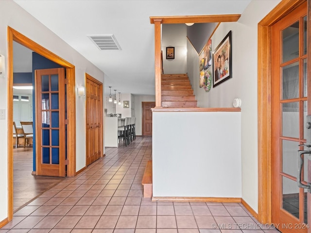 hall with light tile patterned floors