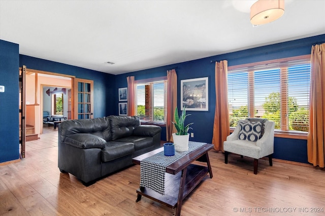 living room featuring light wood-type flooring and plenty of natural light