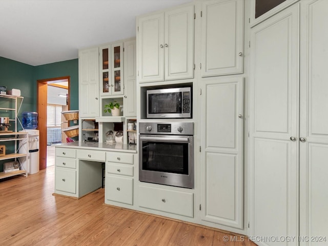 kitchen featuring light hardwood / wood-style floors, white cabinetry, and appliances with stainless steel finishes