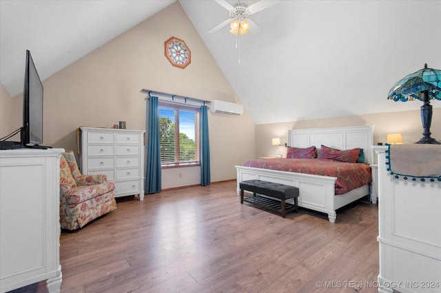 bedroom with a wall mounted air conditioner, hardwood / wood-style floors, high vaulted ceiling, and ceiling fan