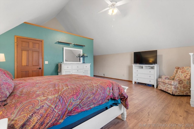 bedroom with light hardwood / wood-style floors, ceiling fan, and lofted ceiling