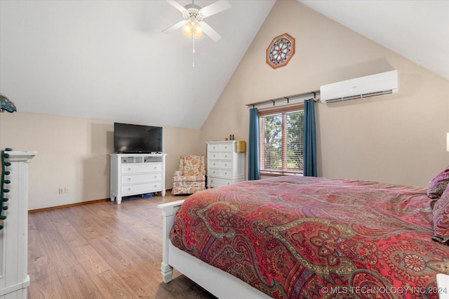 bedroom with vaulted ceiling, hardwood / wood-style flooring, a wall unit AC, and ceiling fan