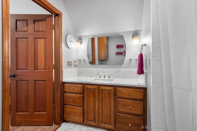 bathroom featuring vanity and vaulted ceiling