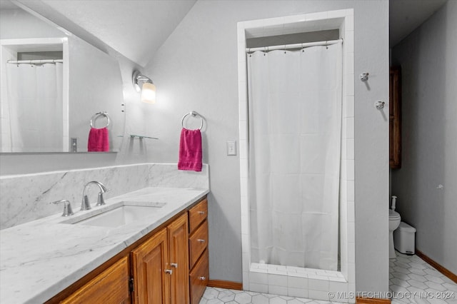 bathroom with walk in shower, vanity, tile patterned flooring, toilet, and lofted ceiling