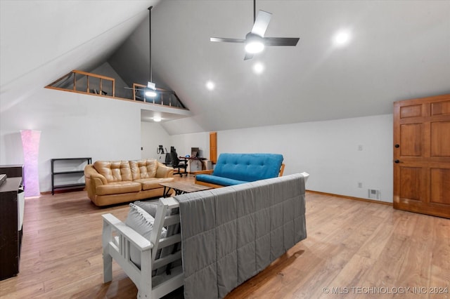 living room featuring light hardwood / wood-style flooring, vaulted ceiling, and ceiling fan