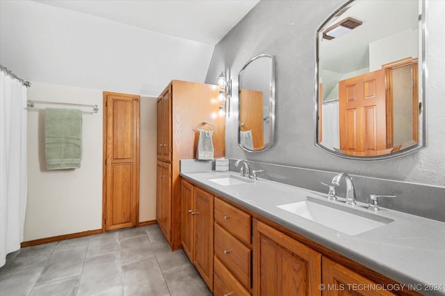 bathroom with tile patterned flooring and vanity