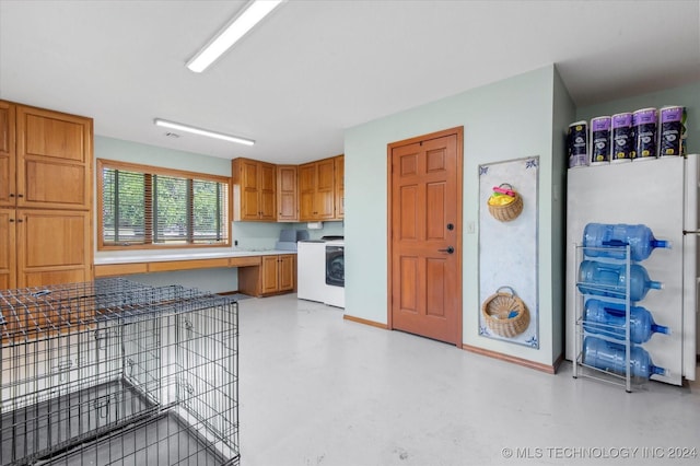 kitchen featuring washer / clothes dryer and white fridge