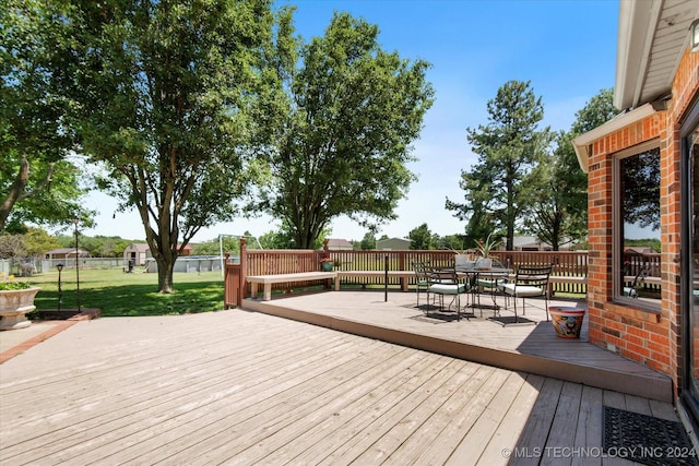 wooden deck featuring a yard