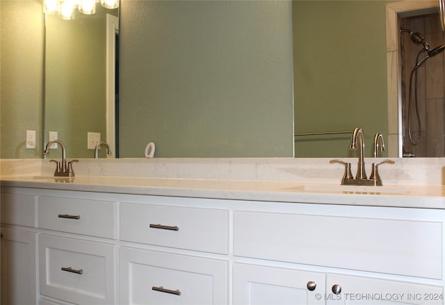 bathroom with a shower and vanity