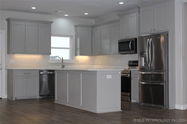 kitchen featuring sink, gray cabinets, dark hardwood / wood-style flooring, and stainless steel appliances