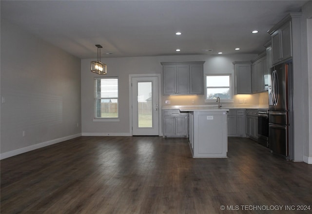 kitchen with refrigerator with ice dispenser, plenty of natural light, and gray cabinetry