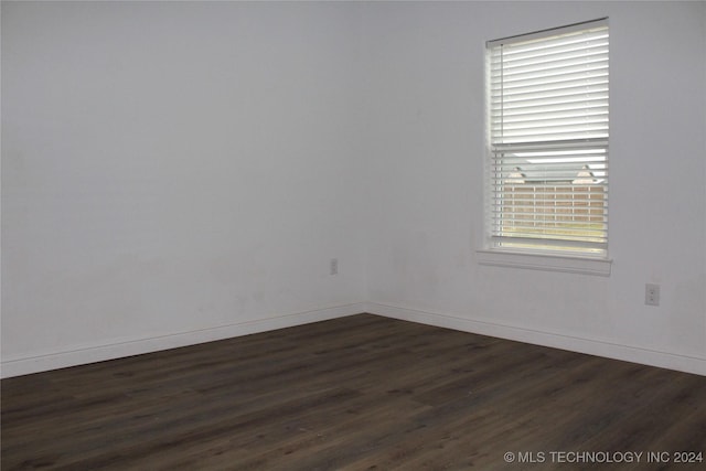 empty room featuring dark wood-type flooring