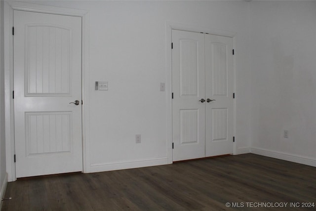 unfurnished bedroom featuring dark hardwood / wood-style floors