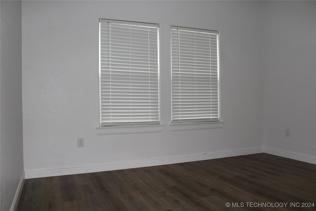 unfurnished room with dark hardwood / wood-style flooring