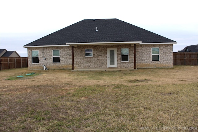 back of house featuring a yard and a patio