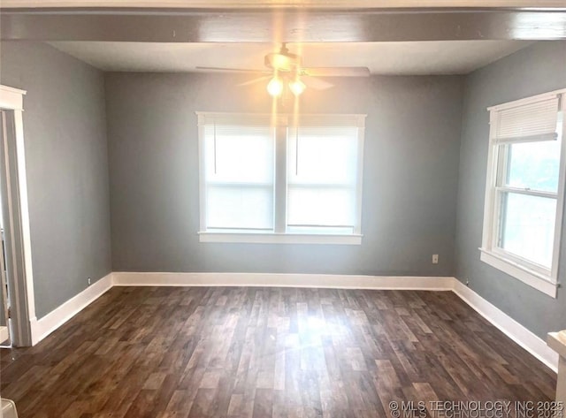 spare room featuring ceiling fan and dark wood-type flooring