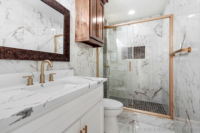 bathroom featuring vanity, toilet, and a shower with door